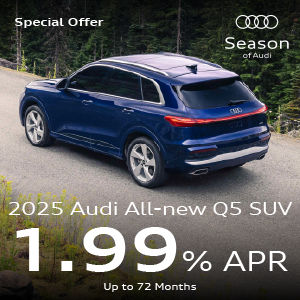 A blue Q5 parked in the forest.